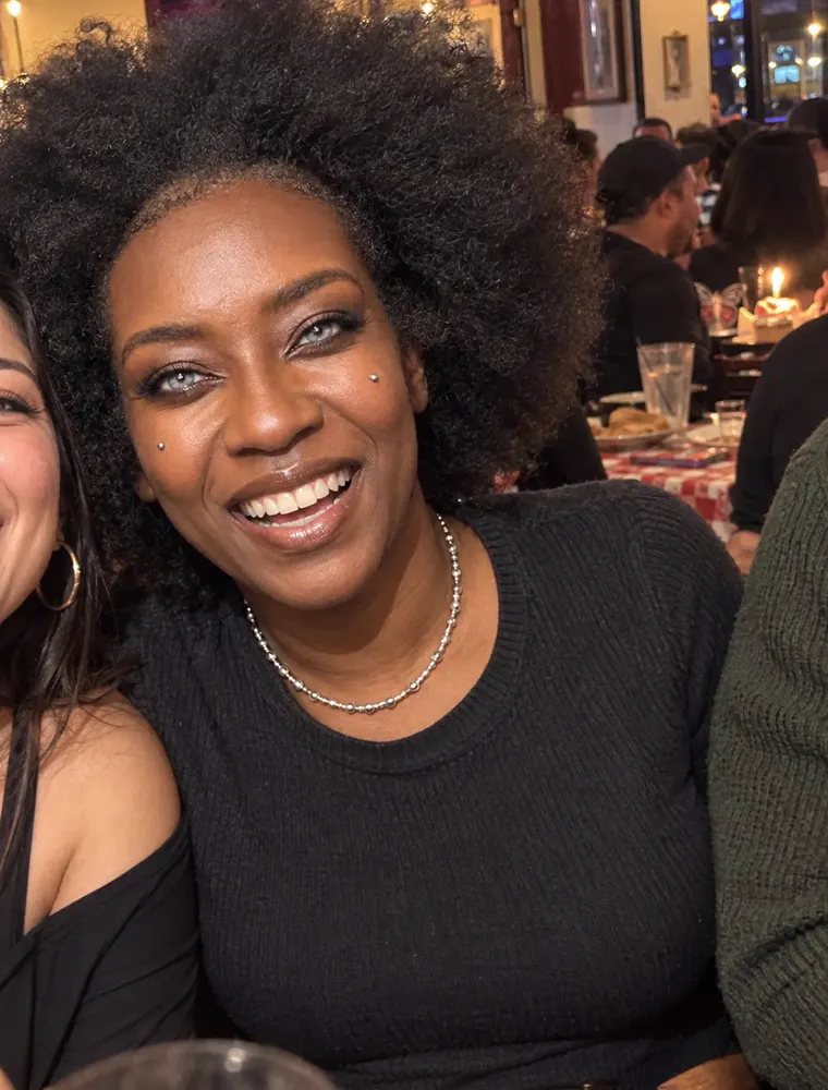 Silver laughing at a group dinner with friends